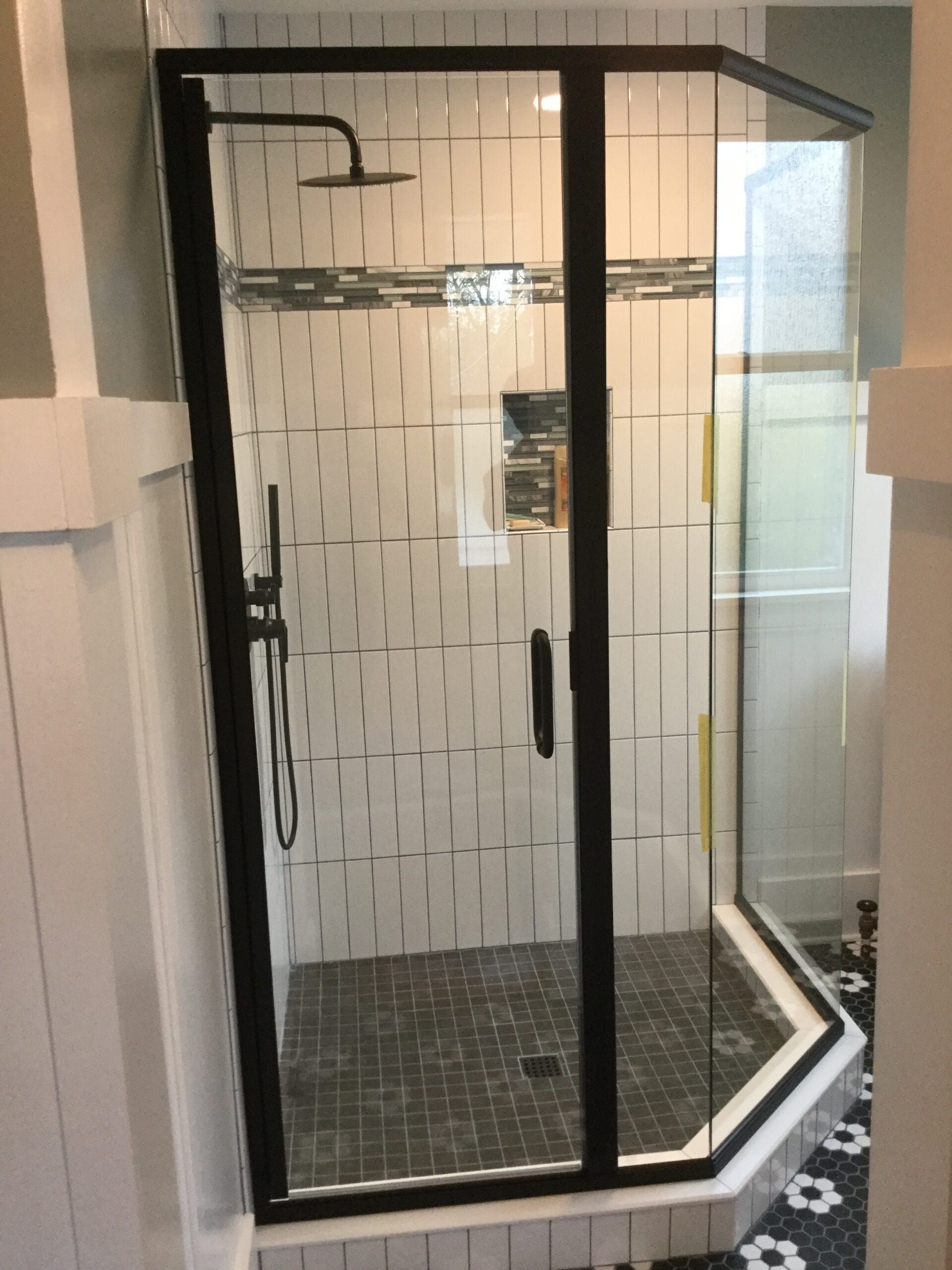 A semi-frameless shower door
